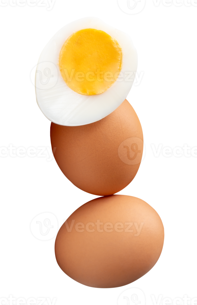 A vertical stack of raw brown chicken eggs and cooked or boiled chicken egg with egg yolk in half isolated with clipping path in file format png