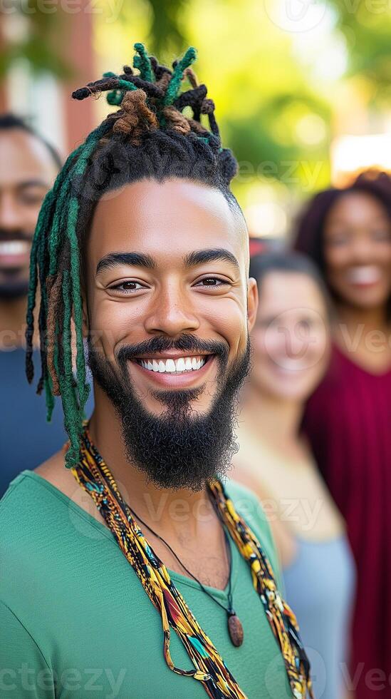 black man with colorful dreadlocks and necklace with his hippie dropout friends photo