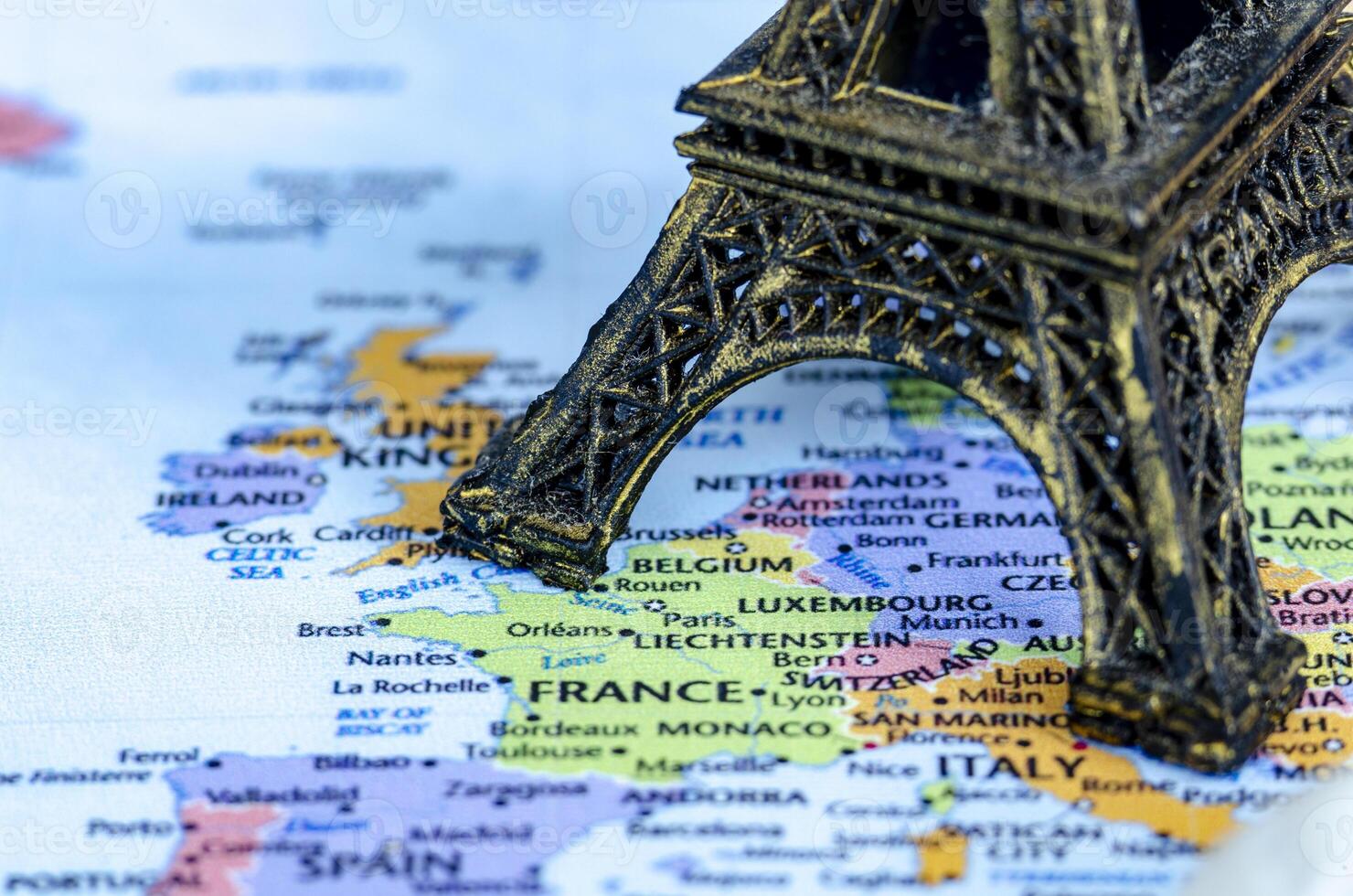 Closed up of miniature Eiffel Tower placed on a world map. Travel destination concept photo