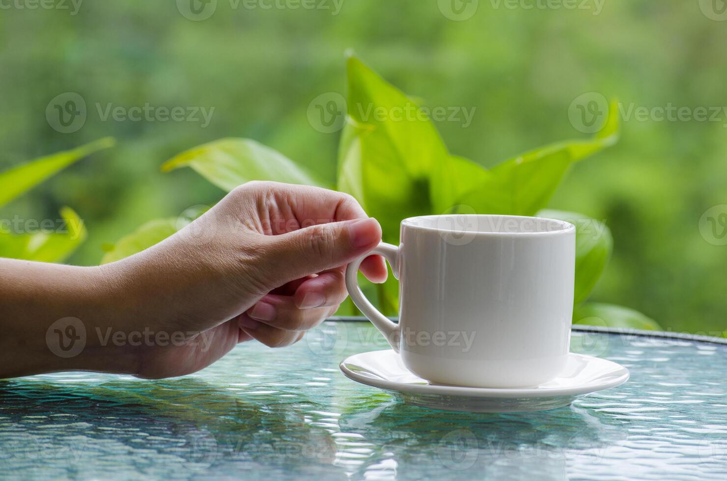 Hand holding a cup with customizable space for mockup photo