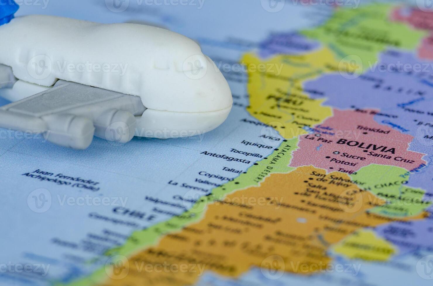 Close up of small toy airplane placed on a world map. Holiday and travel concept photo