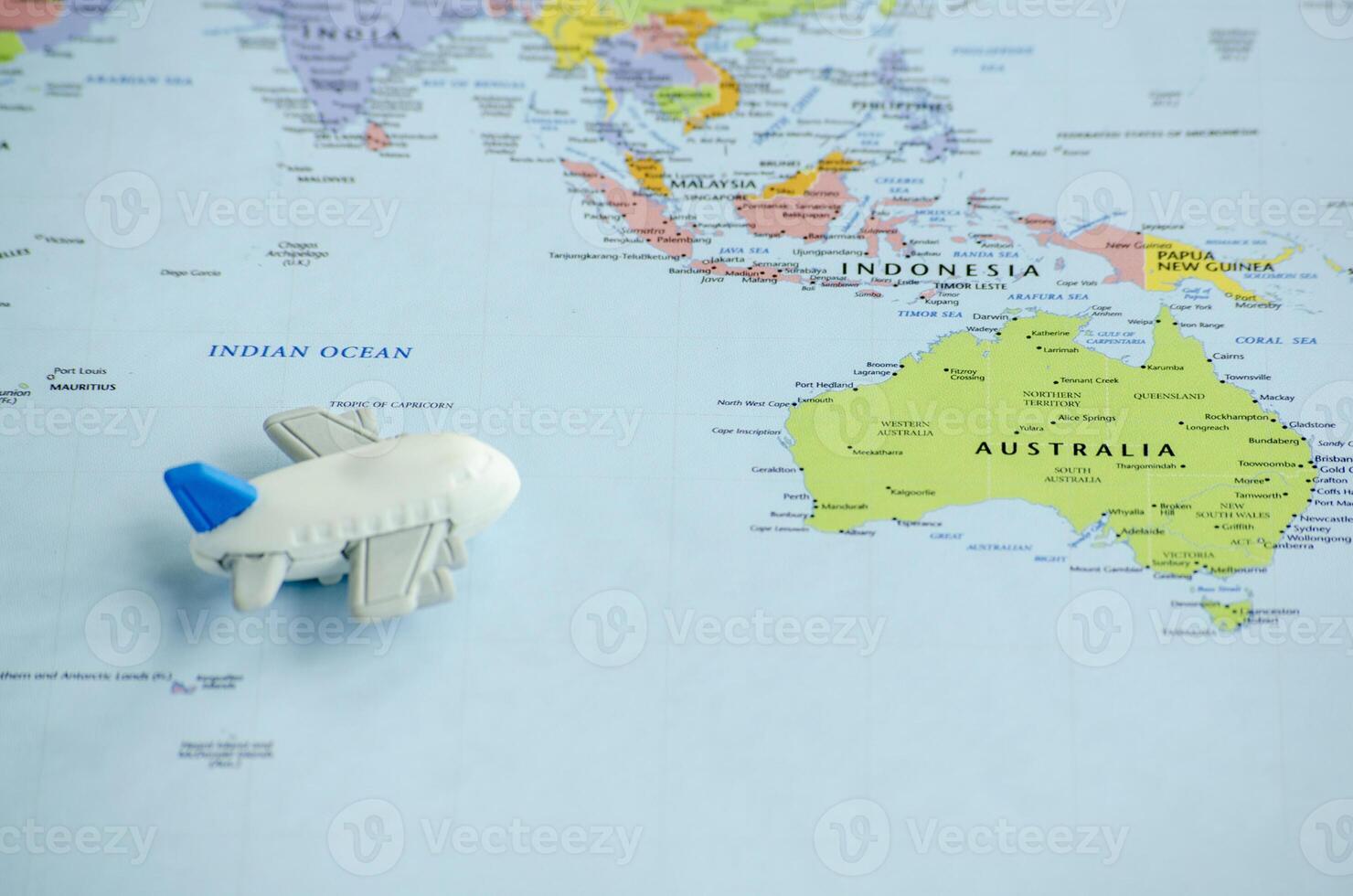 Small toy airplane flying on world map.Travel and destination concept photo