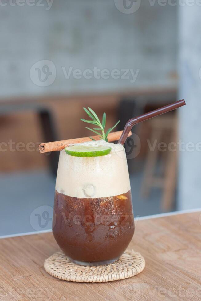 a drink with cinnamon and a cinnamon stick photo