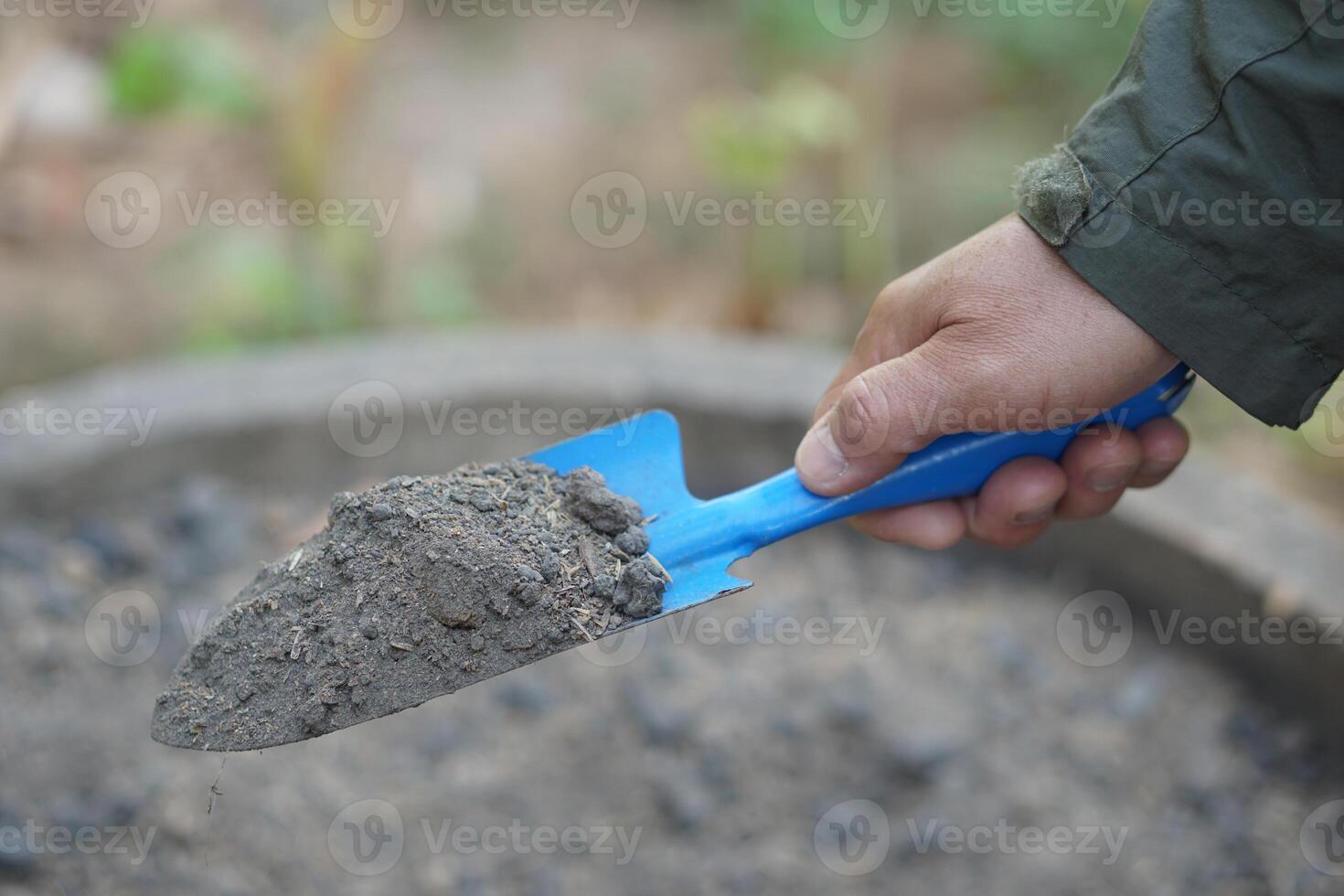 Hand held trowel of sample soil in garden. Concept, soil quality inspection, research and development for agriculture product. Find the best from different soil type and source photo