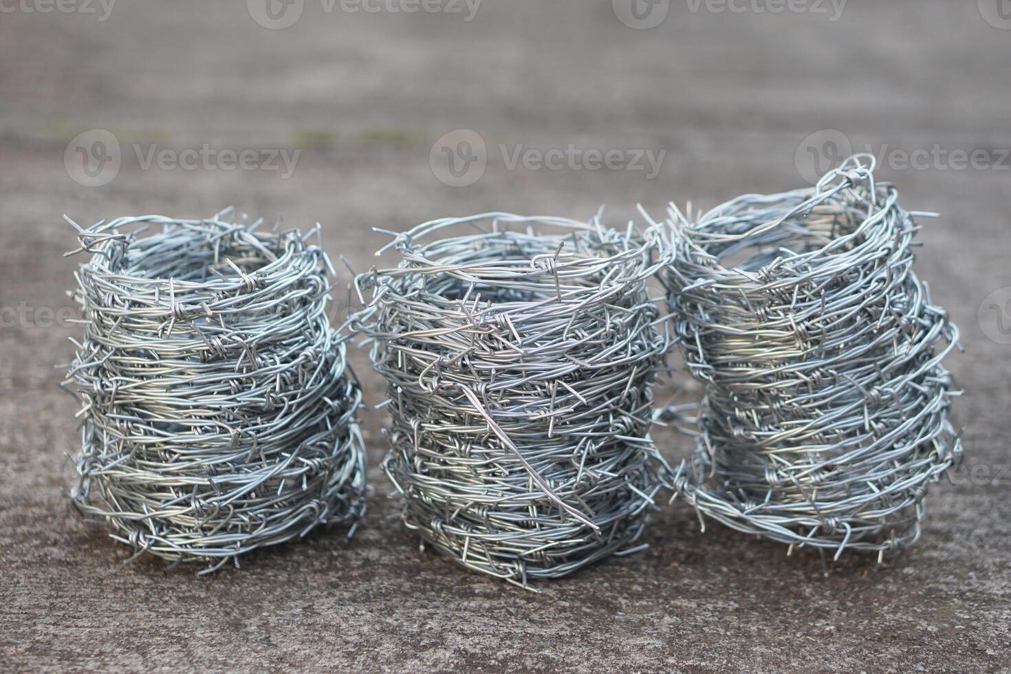 Rolls of metal barbed wire. Concept, construction tool. Barbed wire is used for make fences , secure property ,make border to show the territory of area. photo