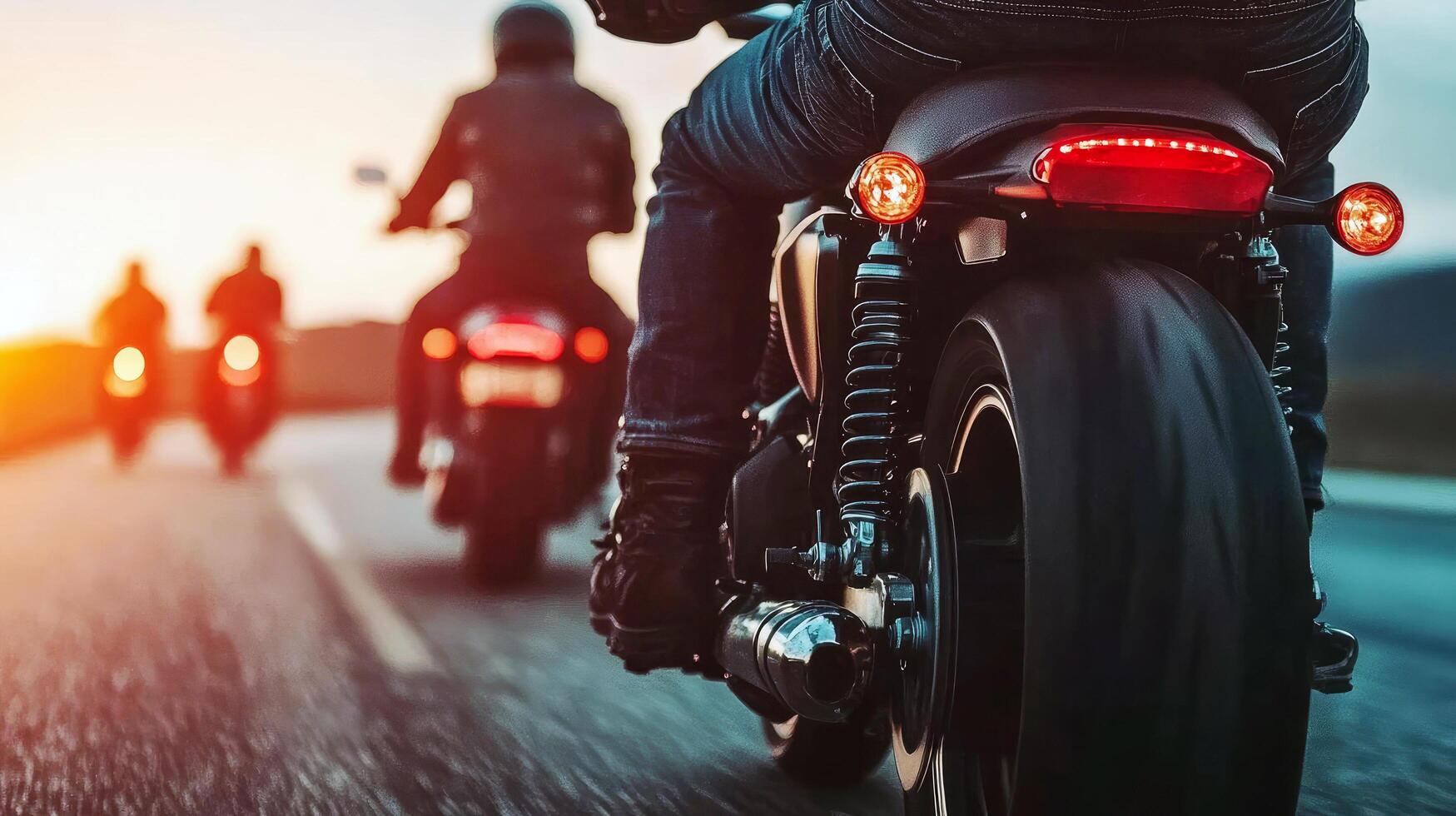 Motorcycles cruising down the highway at sunset with riders enjoying an evening ride photo