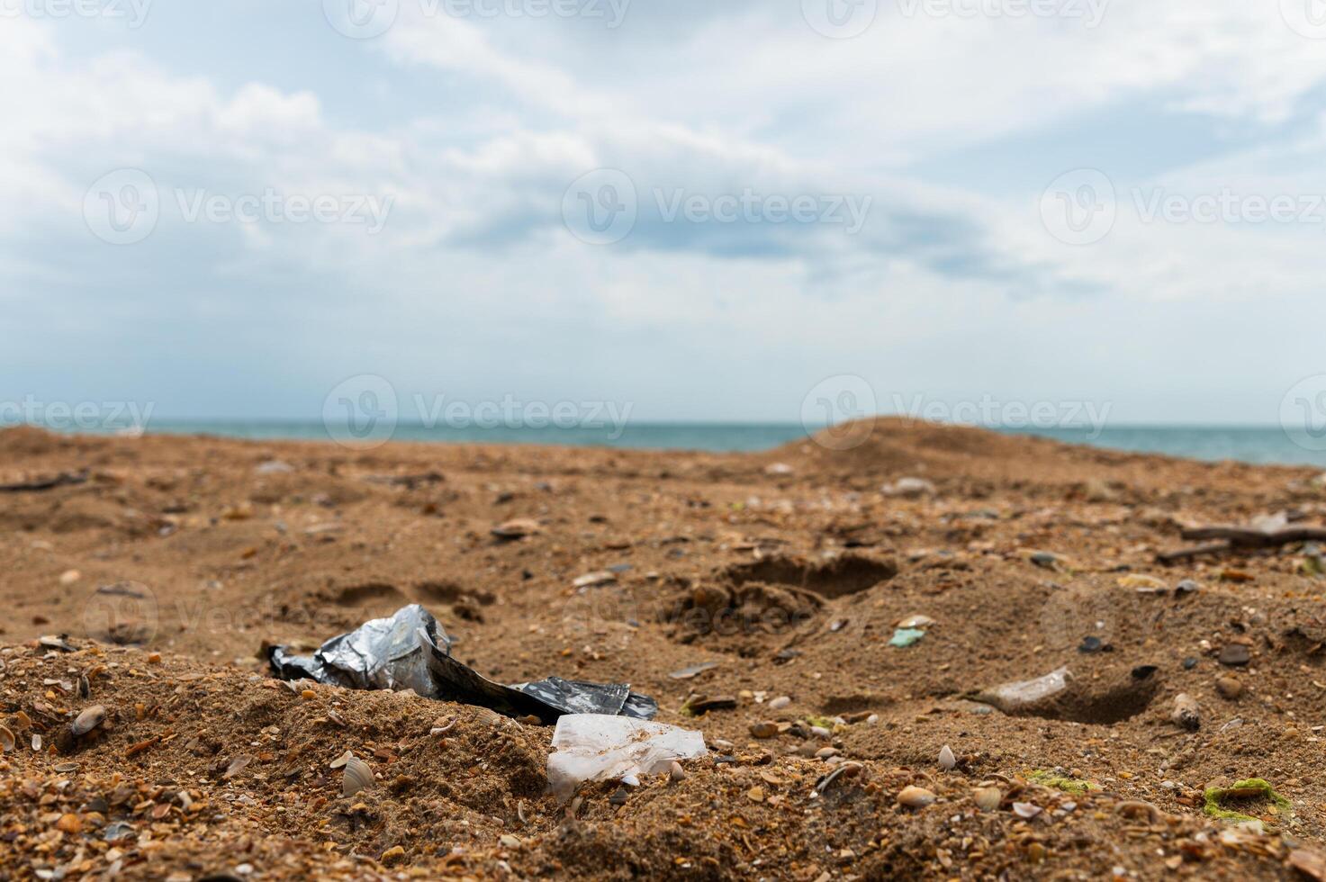 Plastic bottles on the sandy beach. Environmental pollution photo
