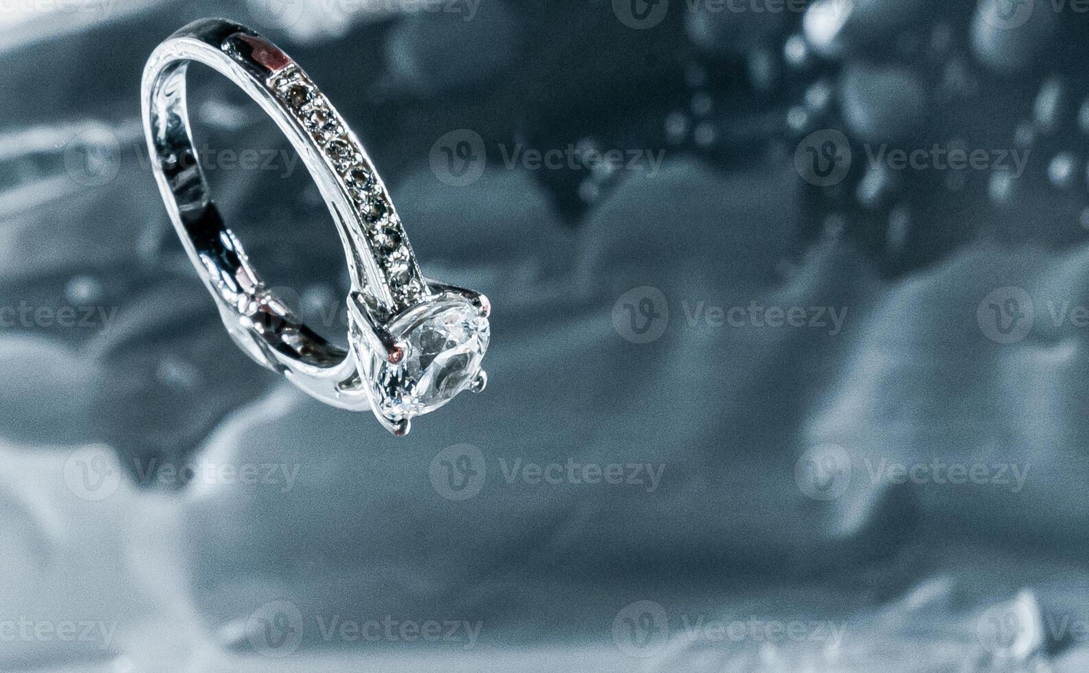 Elegant Diamond Engagement Ring on Reflective Surface photo