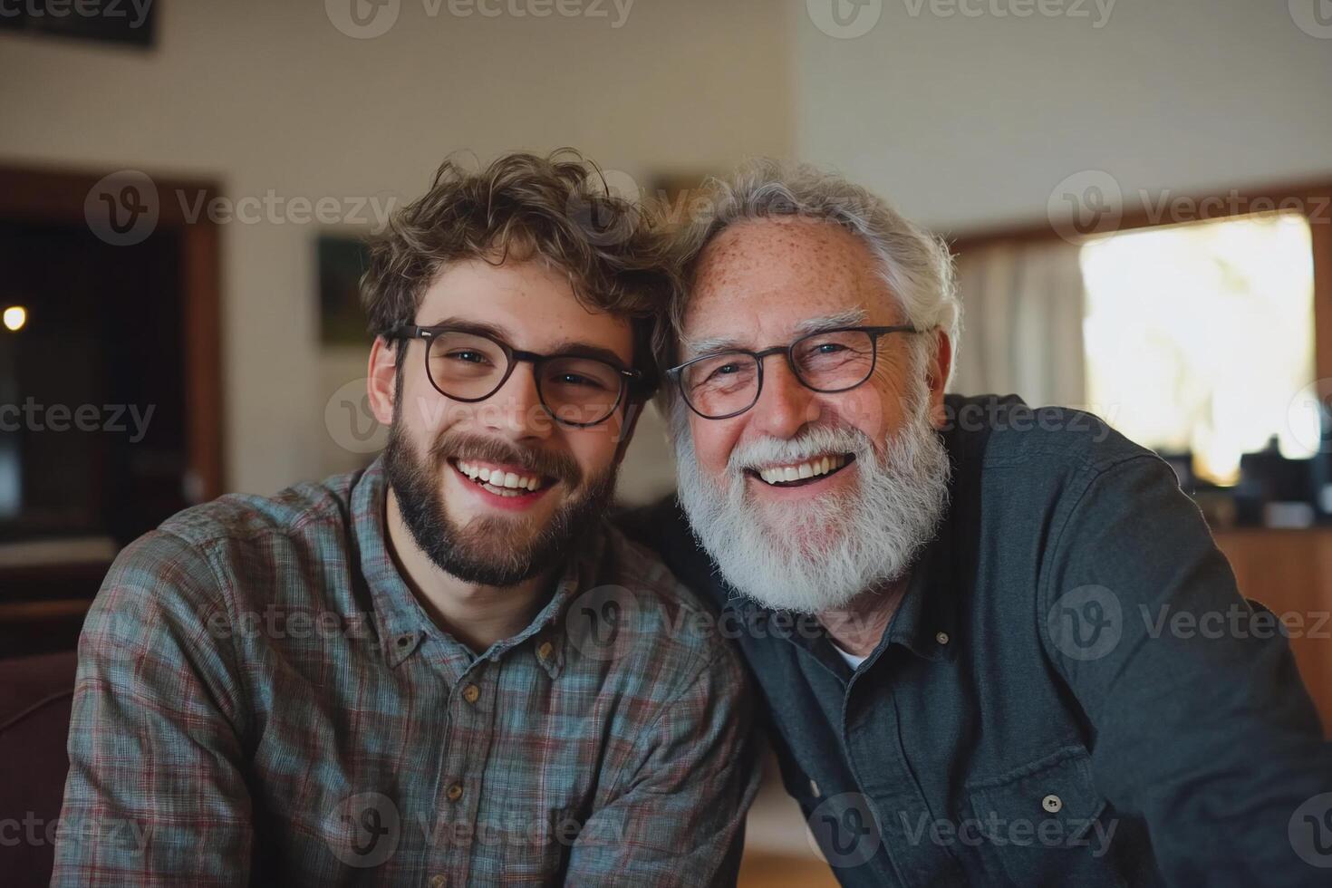 A man with glasses and a beard is smiling next to his father photo