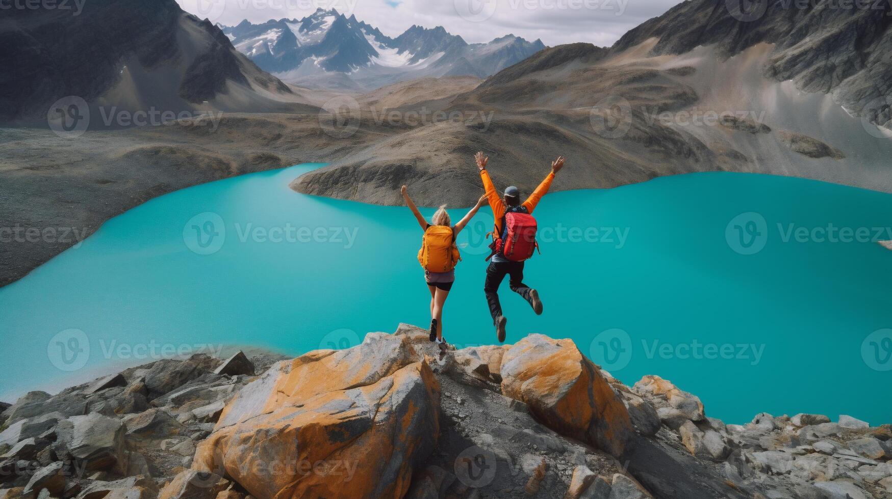 Couple jumps for joy at mountain lake photo