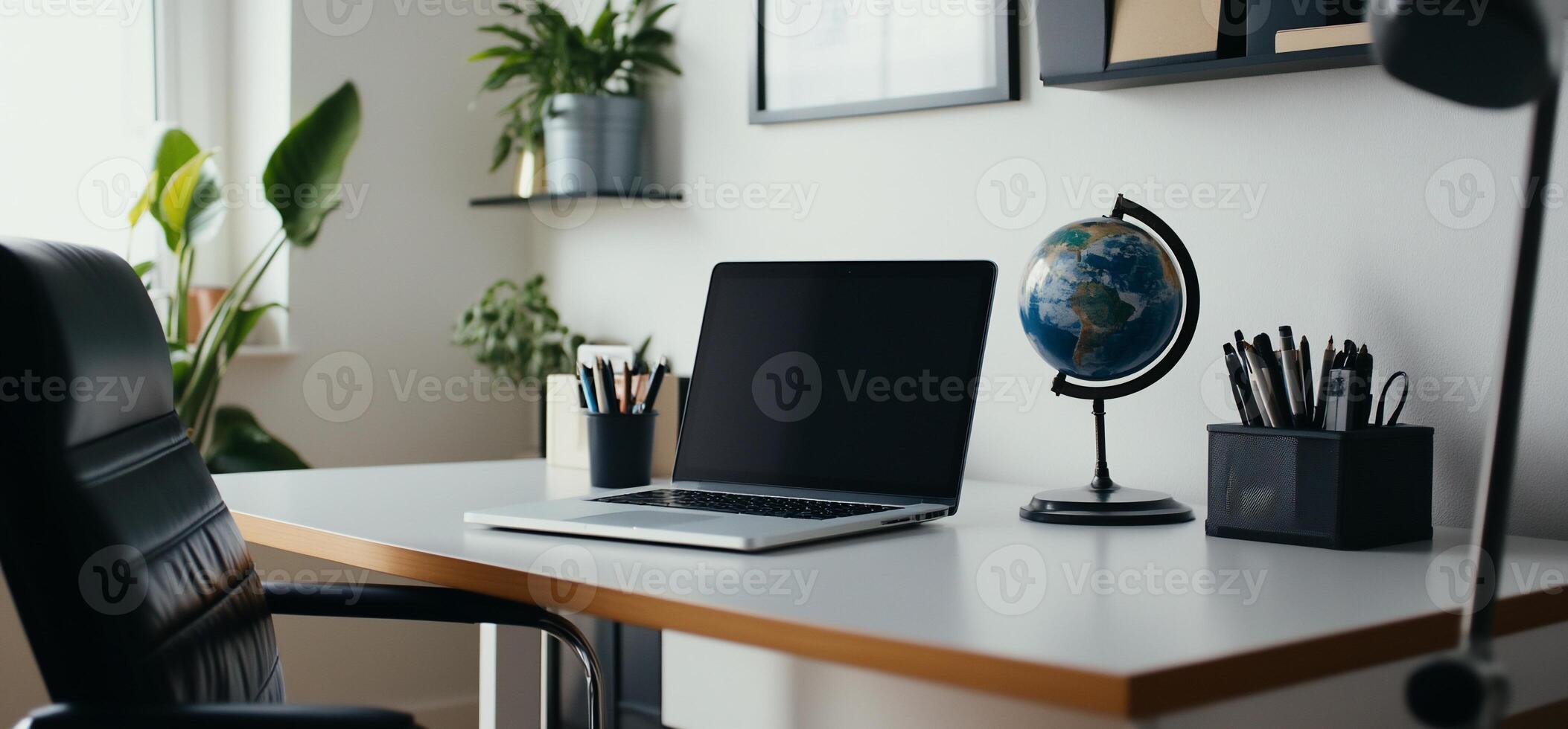 Modern Workspace with Laptop and Globe photo