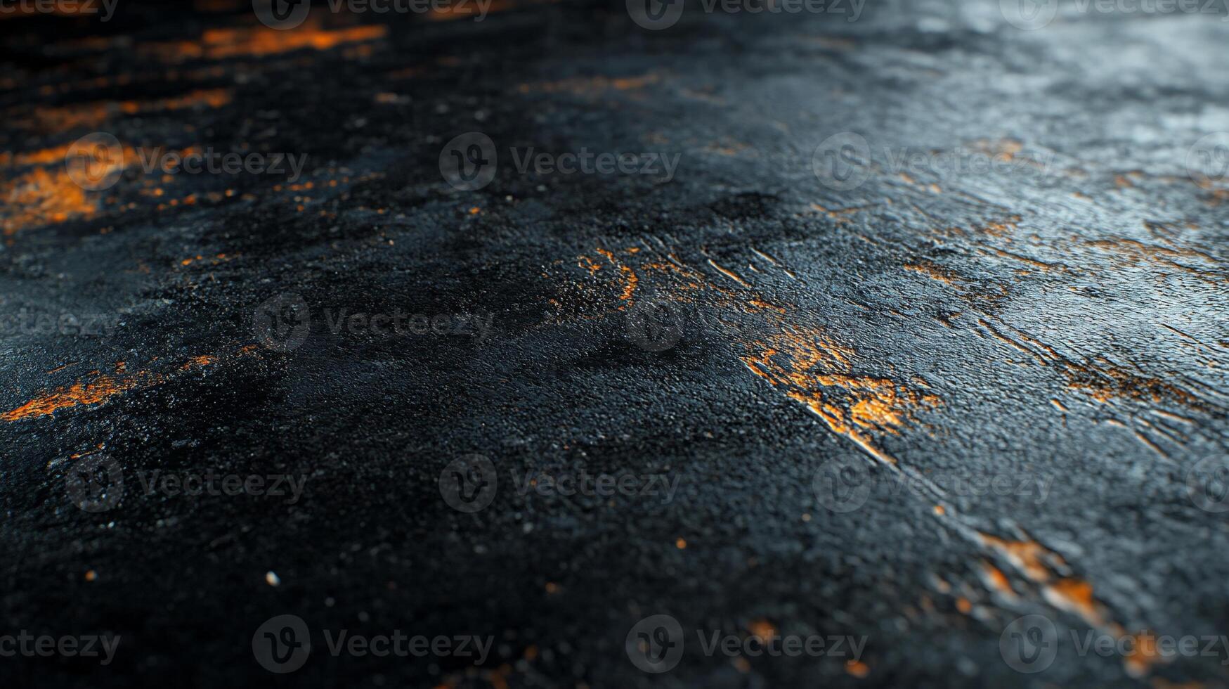 Dark, textured surface with streaks of orange photo
