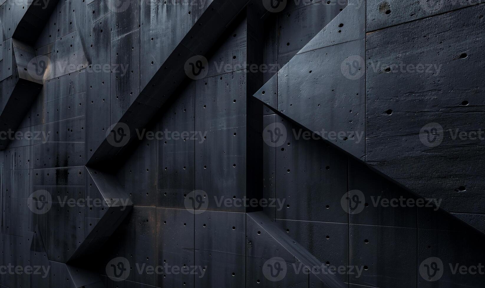 Dark, textured concrete wall with angular shapes photo