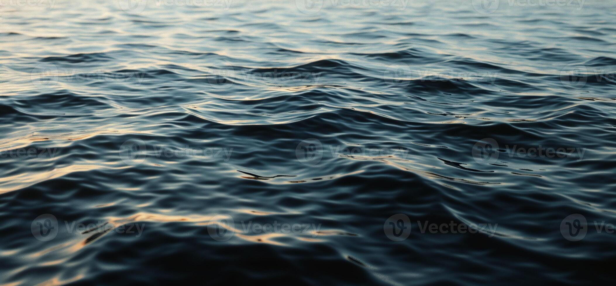 The ocean is calm and dark with waves photo