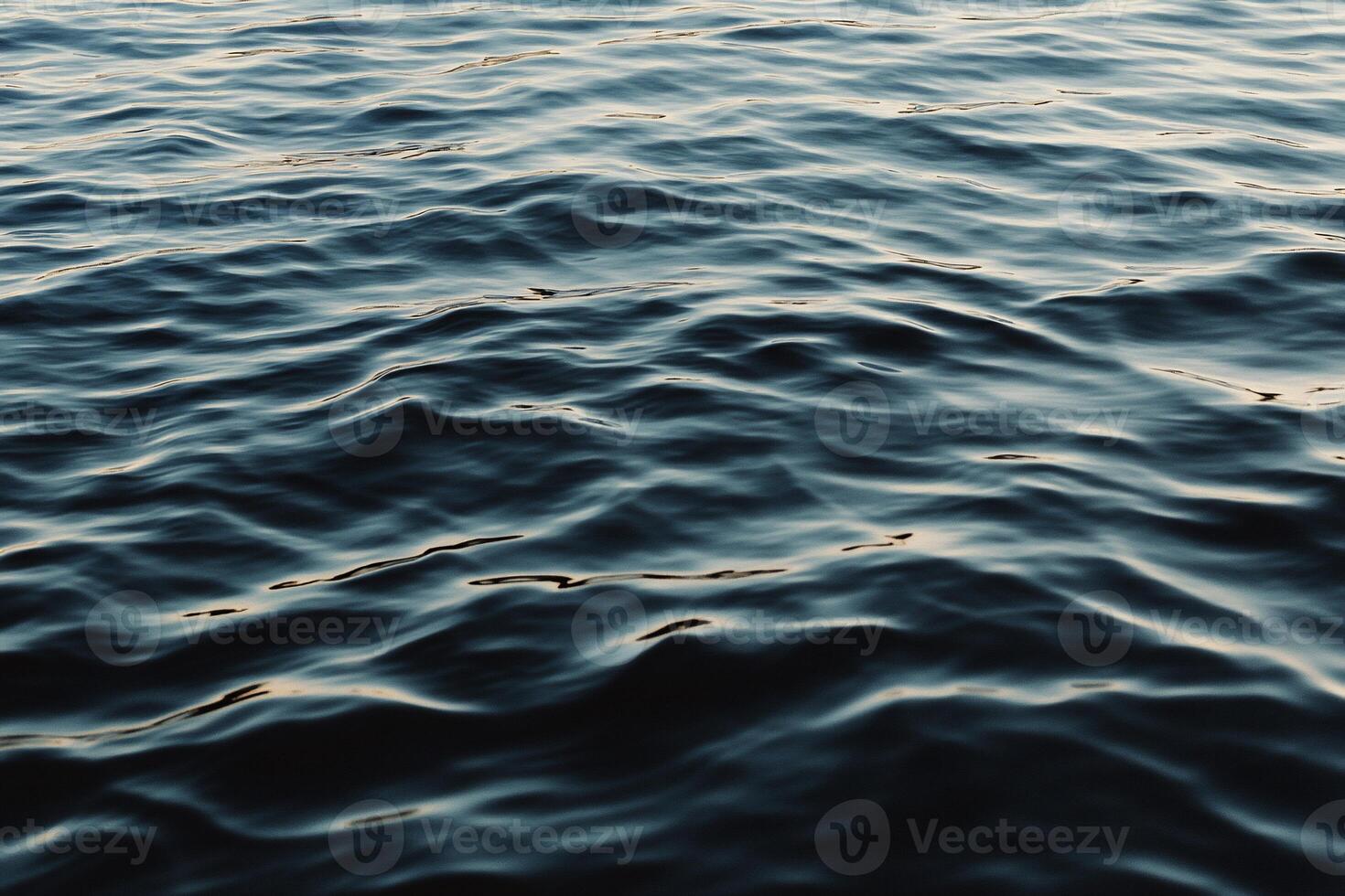 Rippling water surface. Deep blues, subtle waves photo