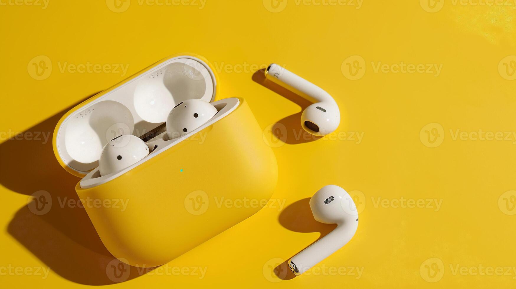 Wireless earbuds in a vibrant yellow case. Stylish, modern, and sleek design photo
