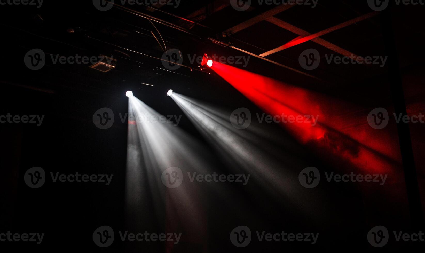 Stage lighting beams in darkness photo