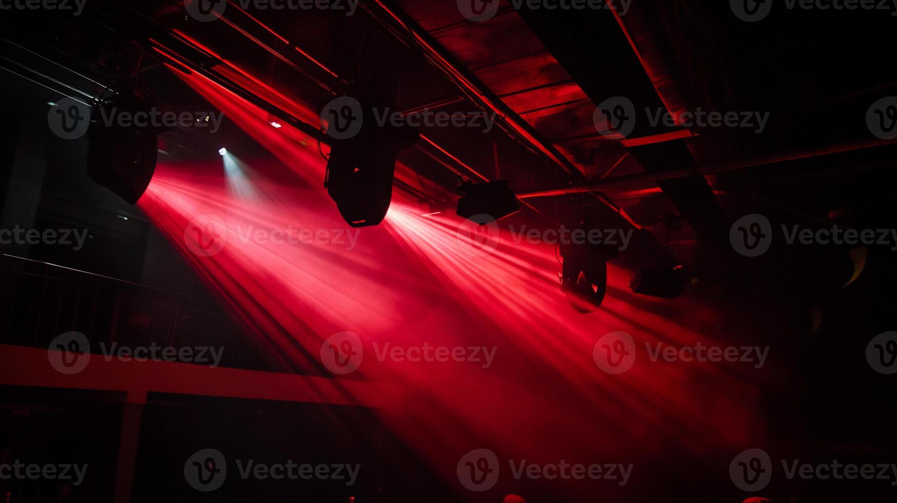Red stage lights illuminating a smoky club photo