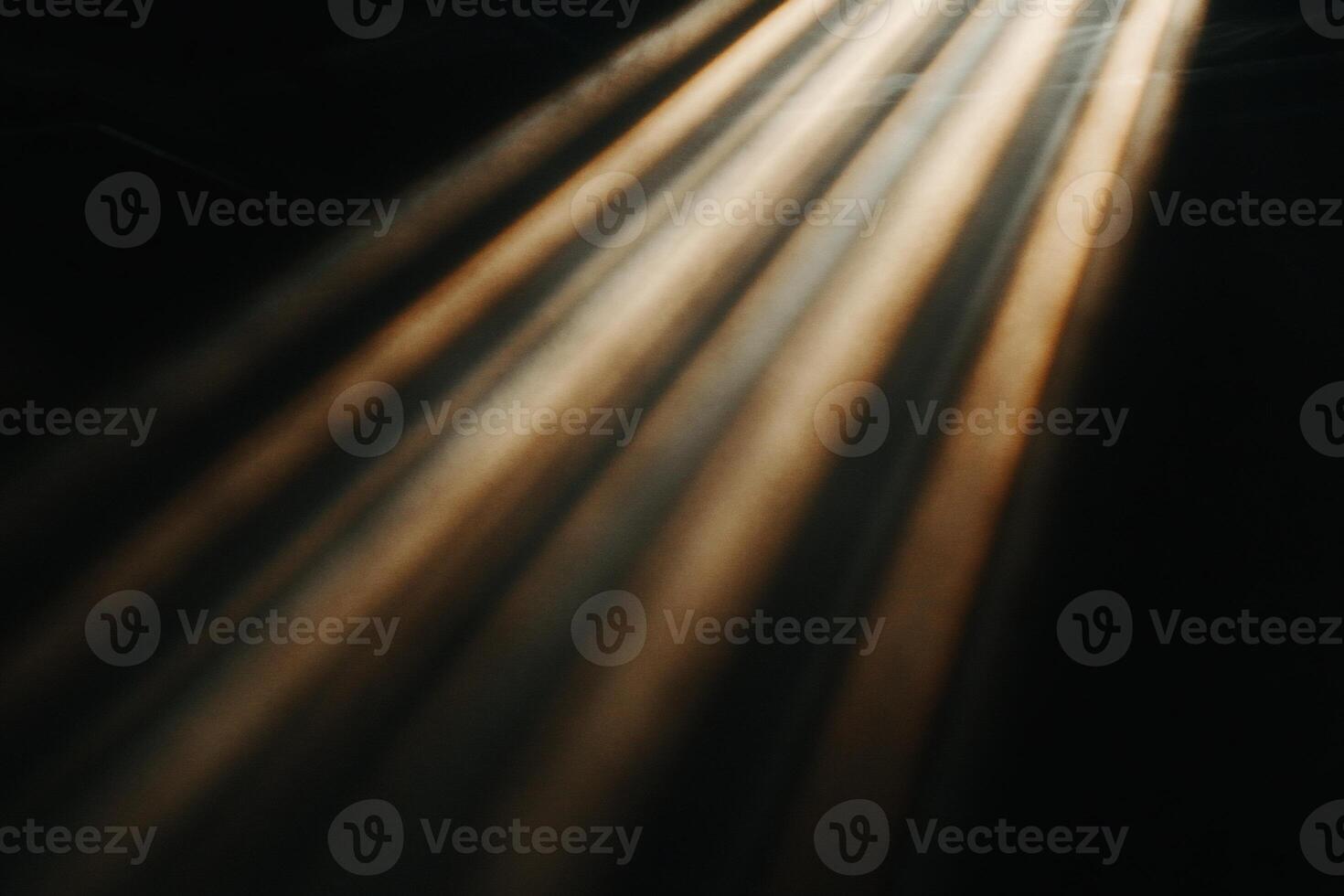 Golden rays of light piercing darkness photo