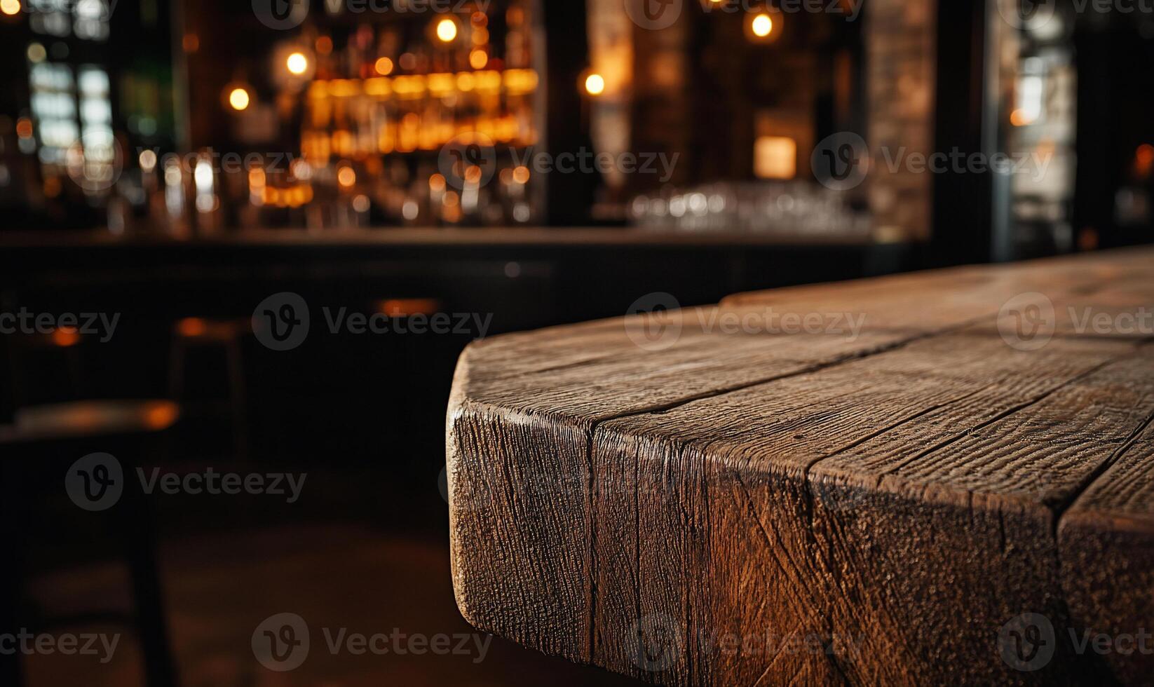 A wooden table in a bar with a bar in the background photo