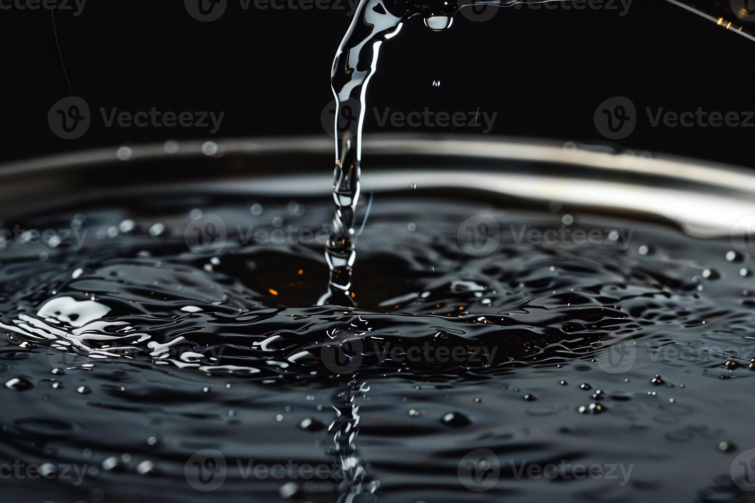 Water pouring into a bowl, creating ripples and splashes photo