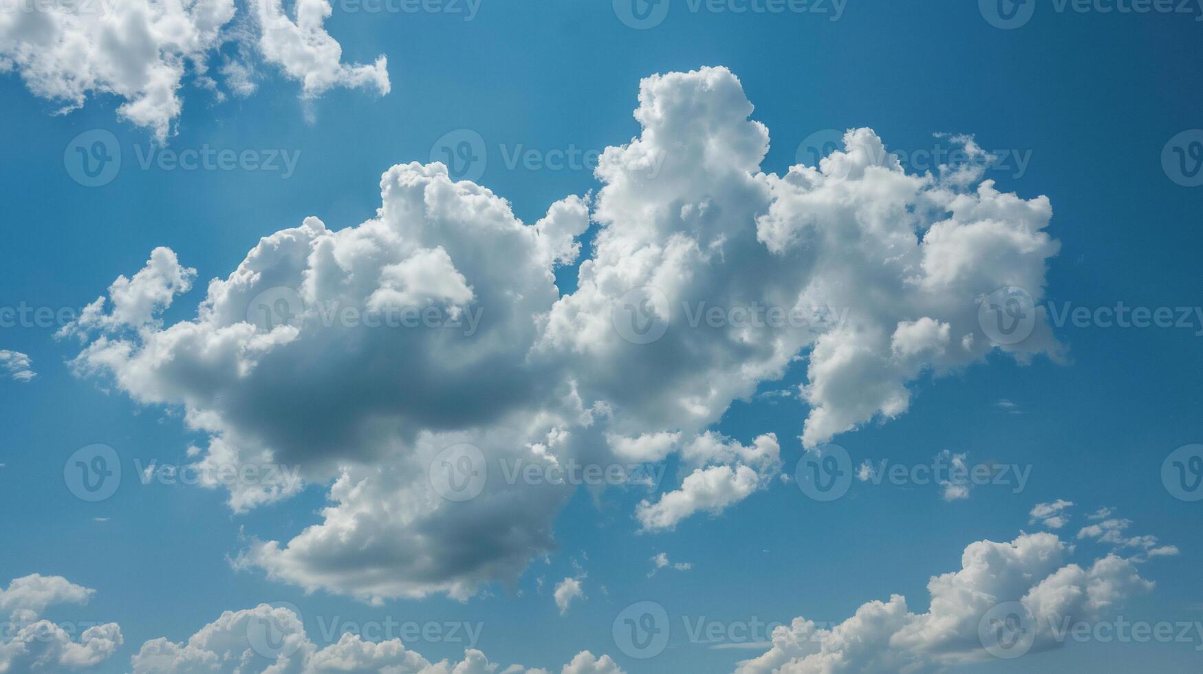 Fluffy cumulus clouds against a vibrant blue sky. Clusters of white puffy clouds fill the image, contrasting beautifully with the clear azure sky. Sunlit areas highlight the texture of the clouds photo