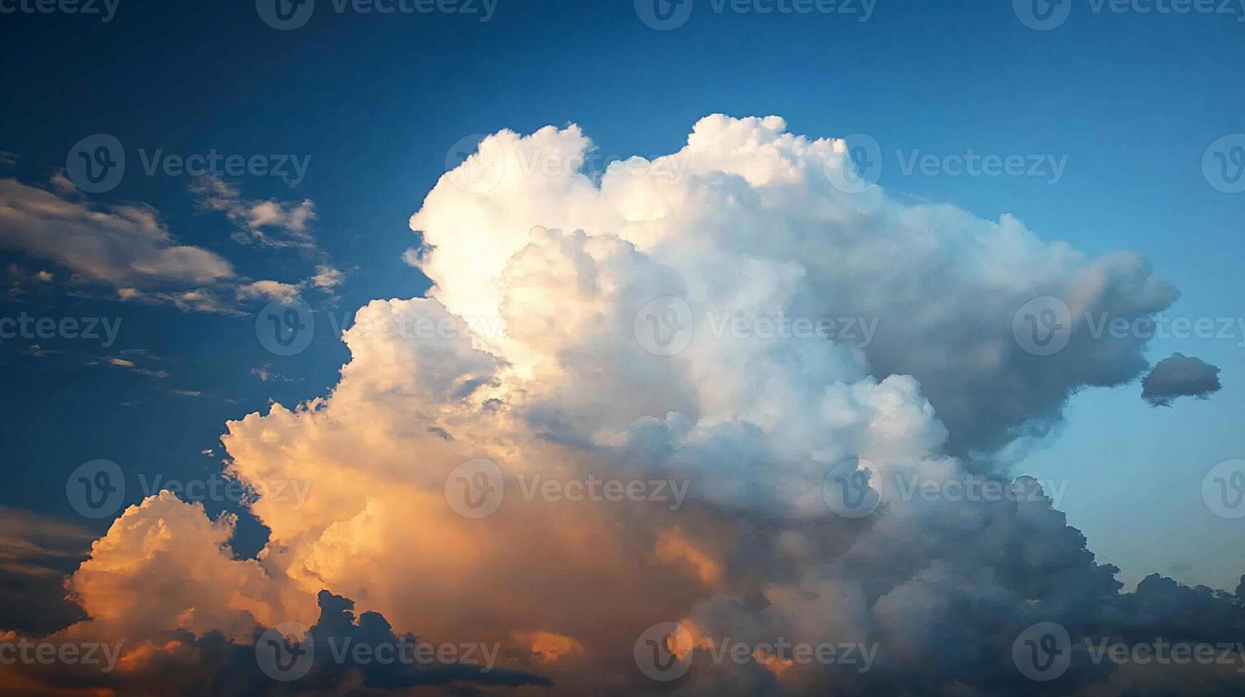 Majestic cumulus cloud formation against a vibrant sunset sky photo