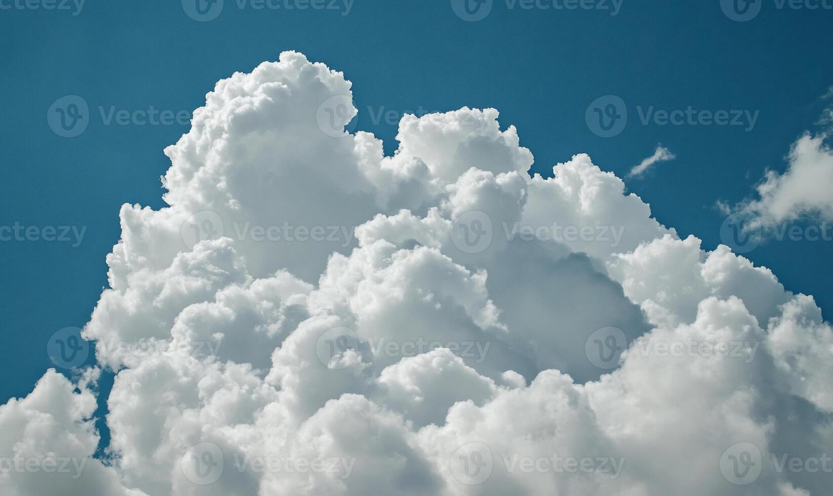 Cumulus clouds fill a vibrant blue sky photo