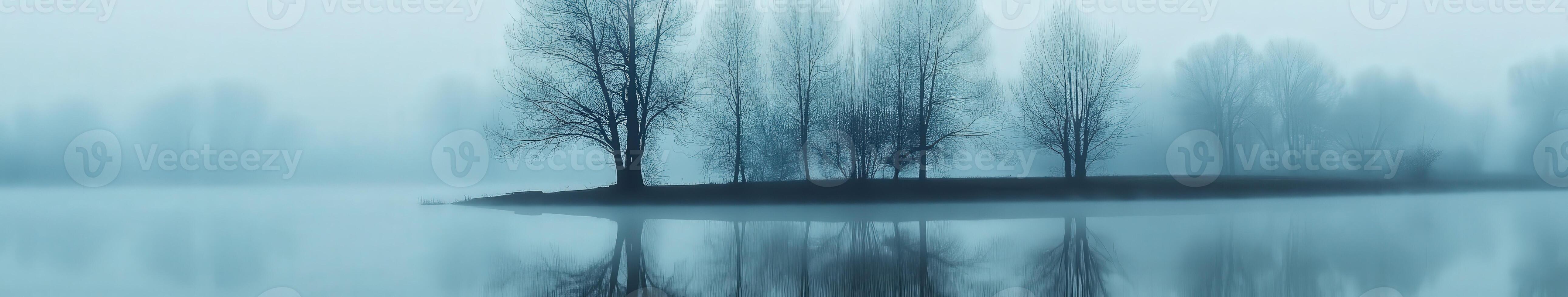 Fog settling over a quiet lakeside photo