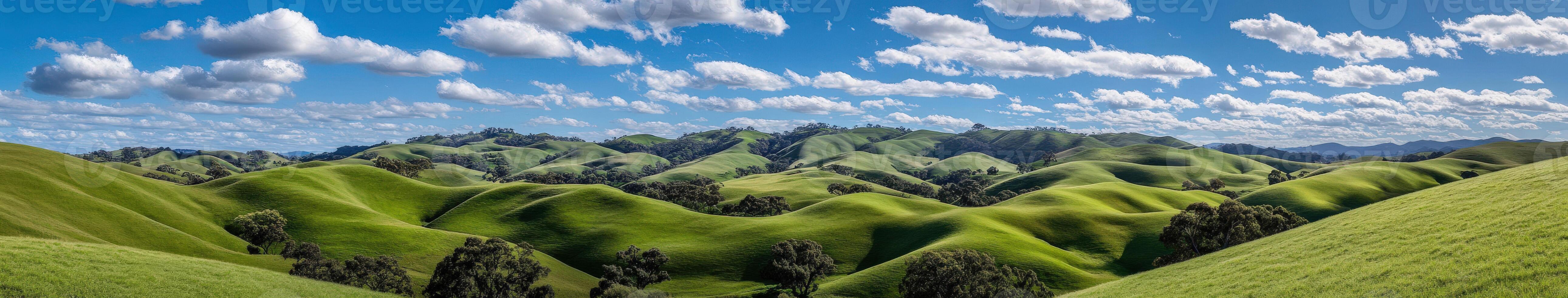 A green hill with clouds and trees photo