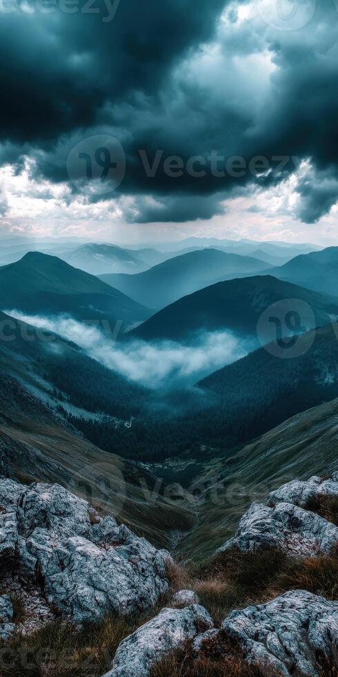 A view of the mountains and clouds from a mountain top photo