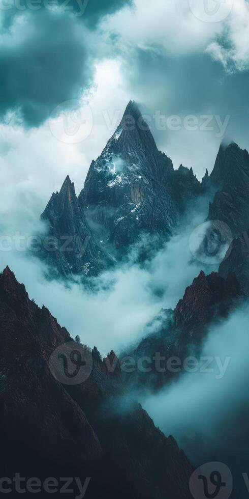 A mountain range with clouds and fog over it photo