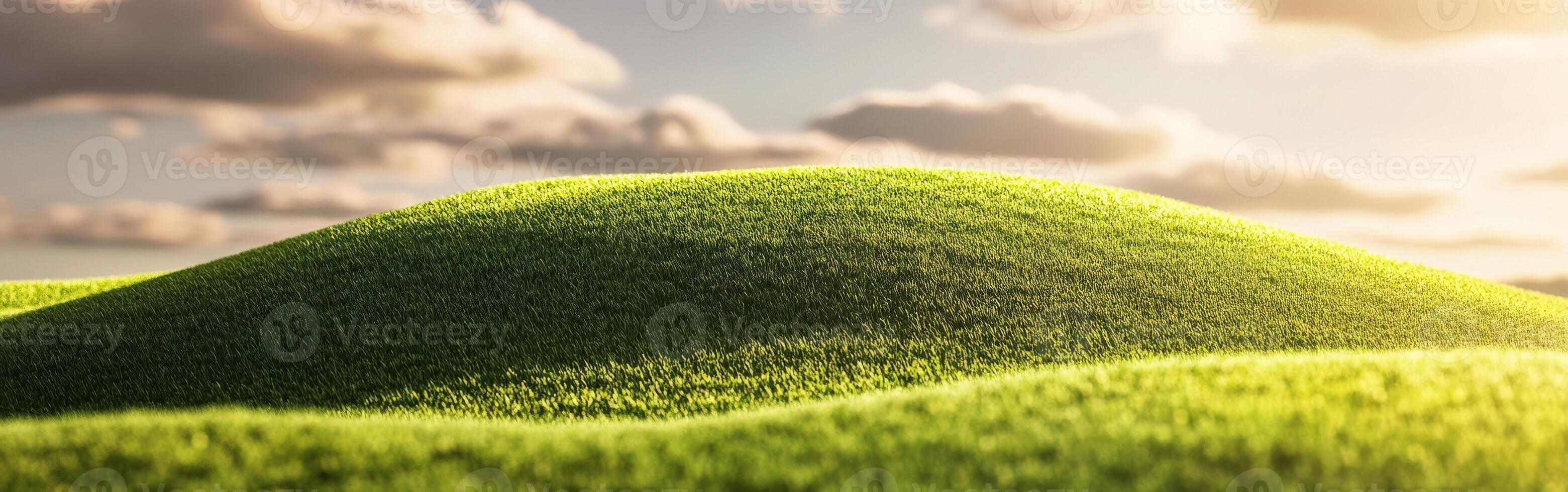 Green grass hill with clouds in the background photo