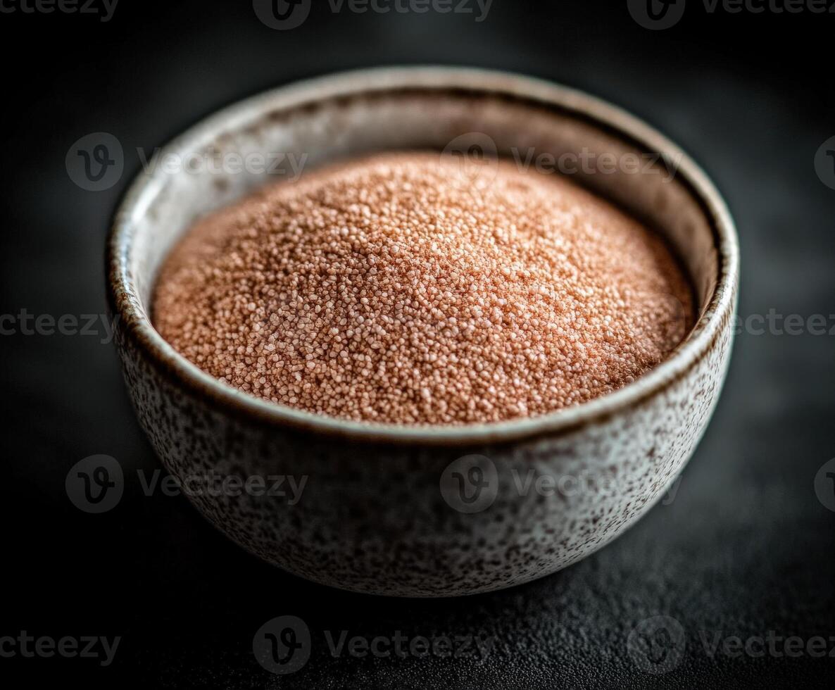 Psyllium husk in a decorative bowl on a dark surface photo