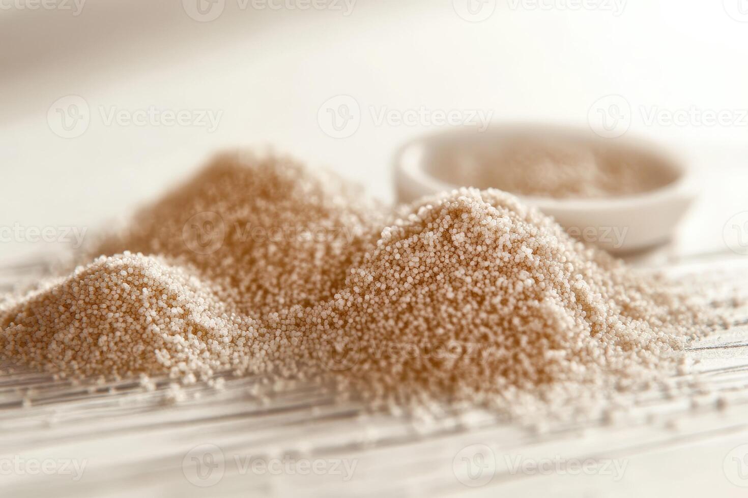Psyllium husk piles on a surface with a bowl in background photo