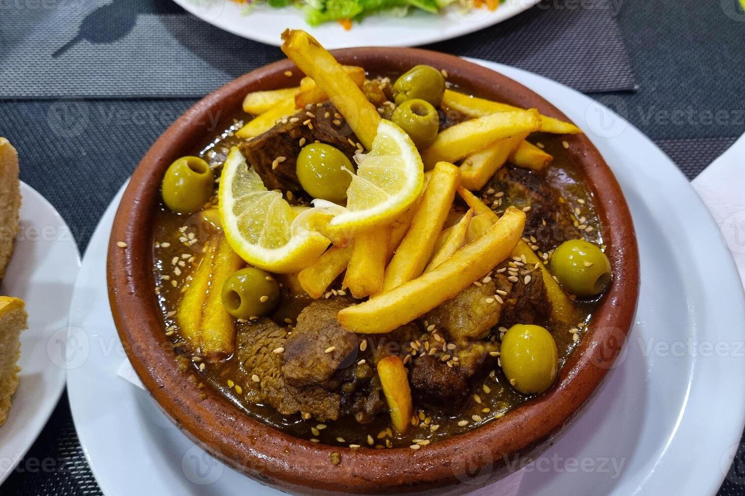 Savory Moroccan Tagine with Olives, Lemon, and Fries for Culinary Enthusiasts photo