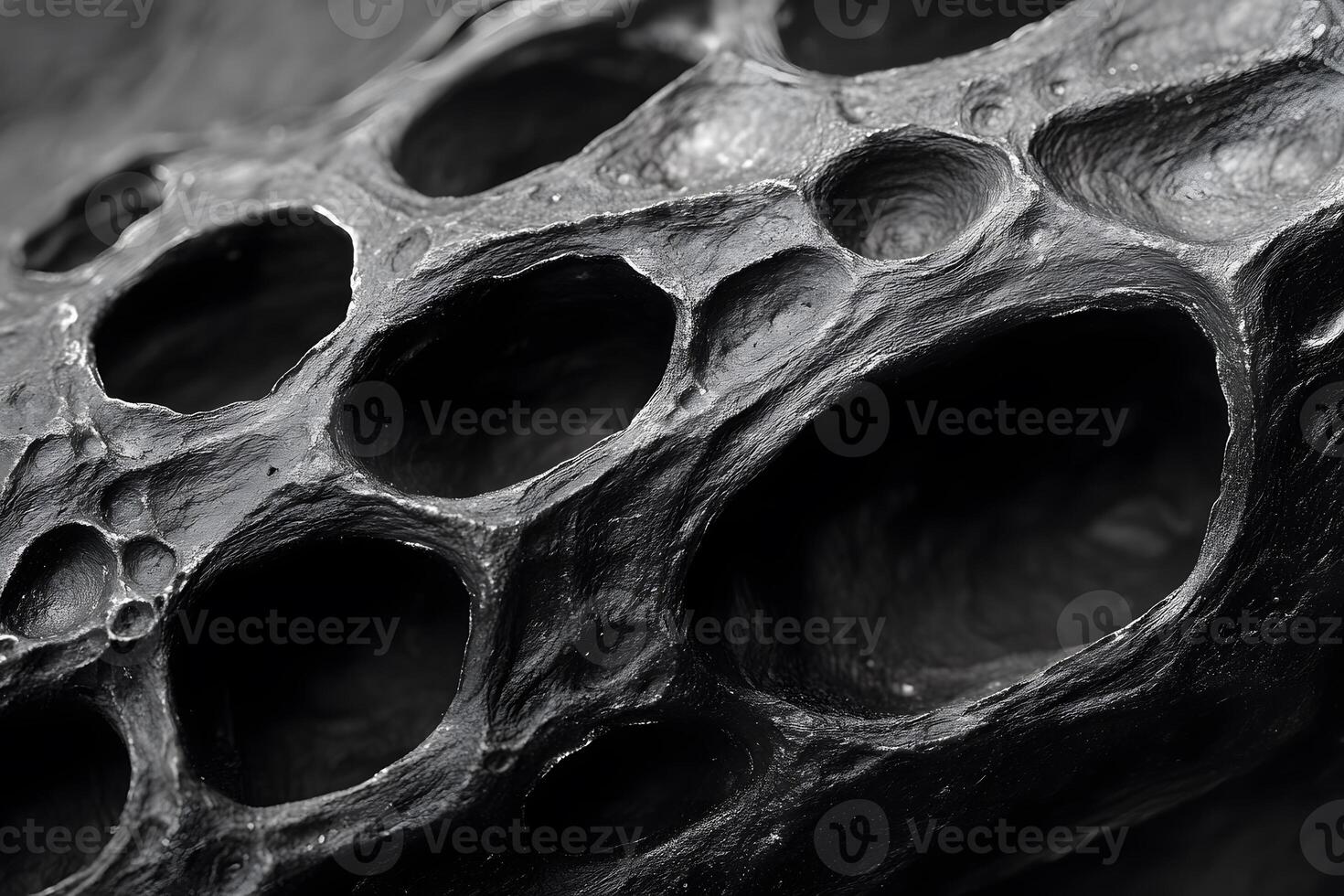 Abstract Close-up of Organic Black Rock with Porous Texture for Modern Design photo