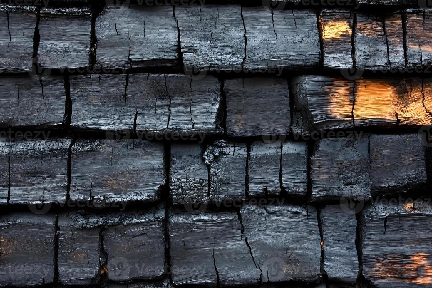 Charred Wood Texture with Golden Highlights for Design and Backgrounds photo