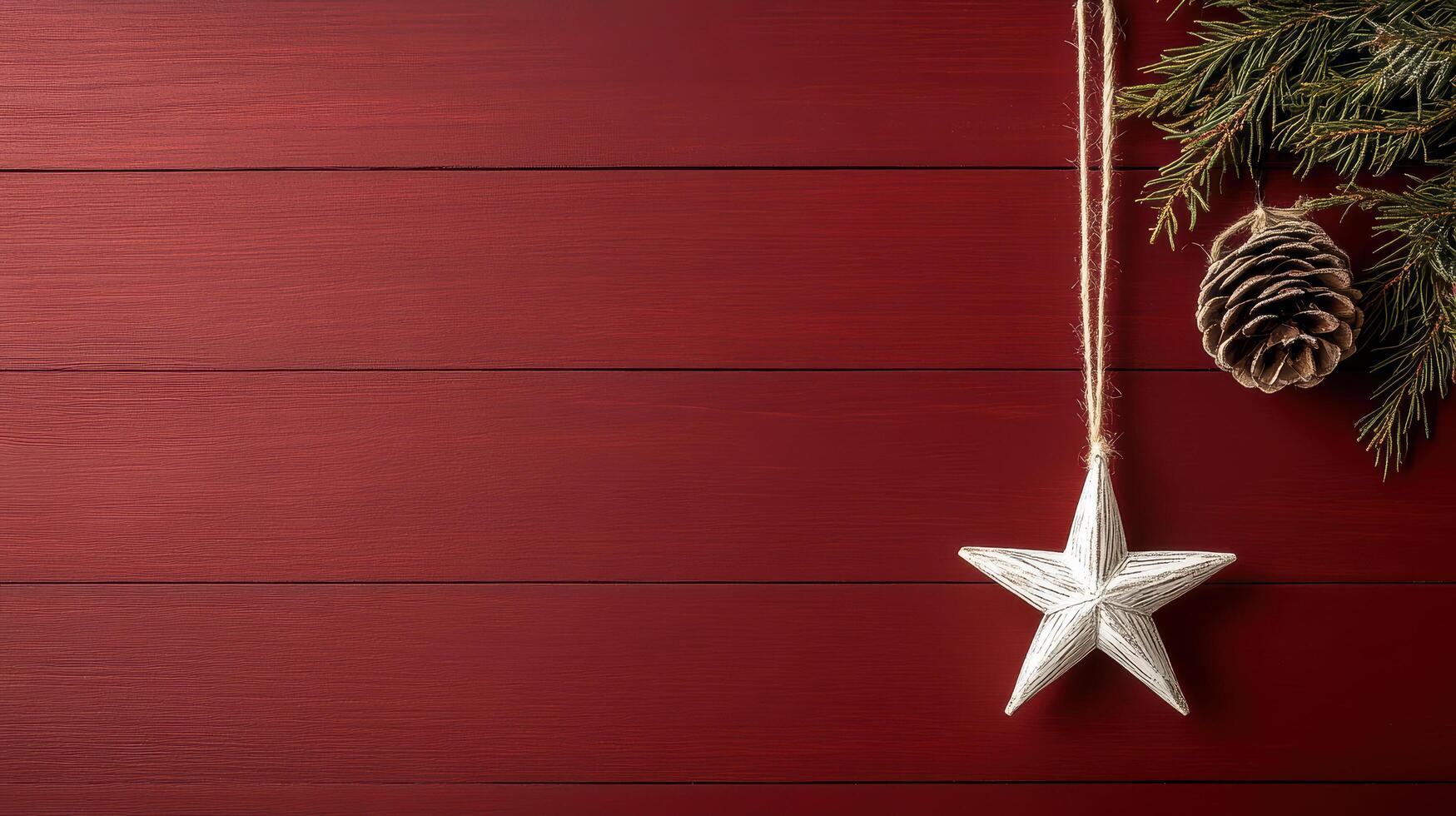 star ornament hanging on deep red background with pinecones and greenery photo