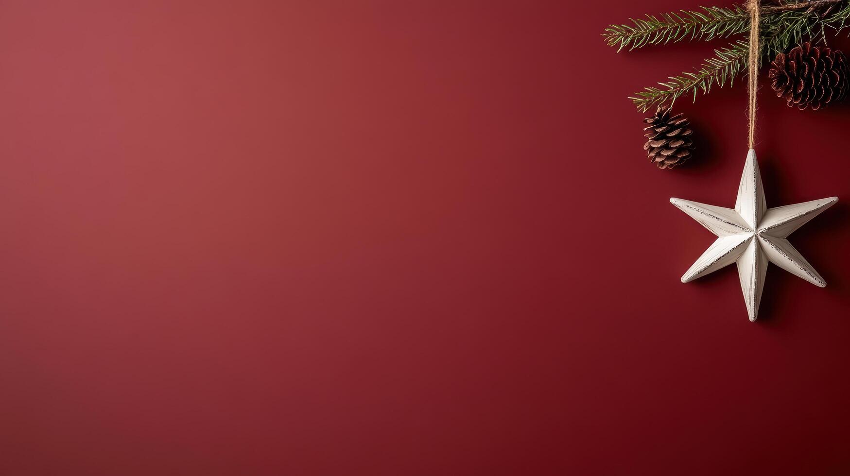 single star ornament hangs on deep red background with pinecones photo