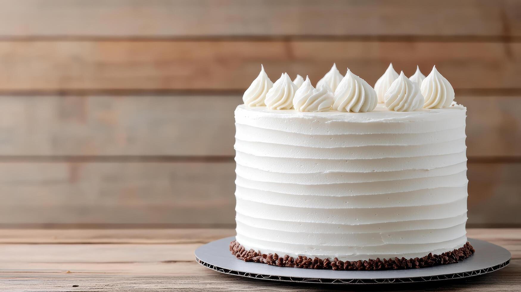 delicious homemade cake with smooth white frosting and decorative swirls top, perfect for photo