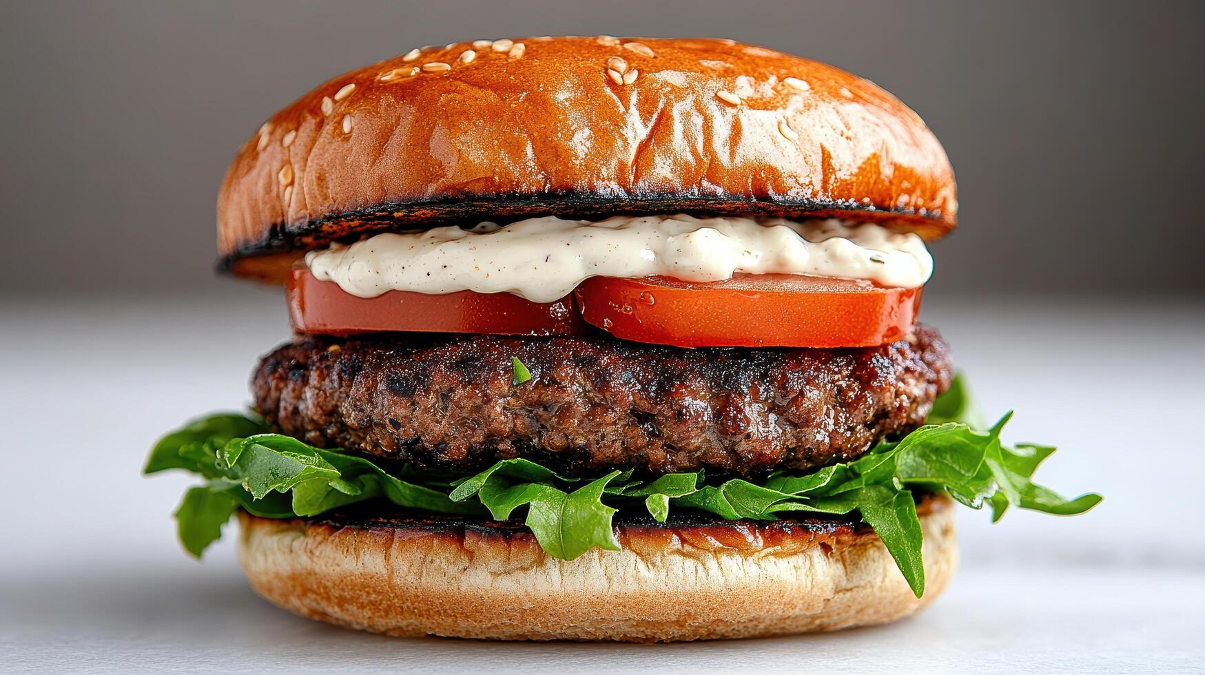 Juicy burger with sesame seed bun, fresh lettuce, tomato, and creamy sauce, perfect for meal photo