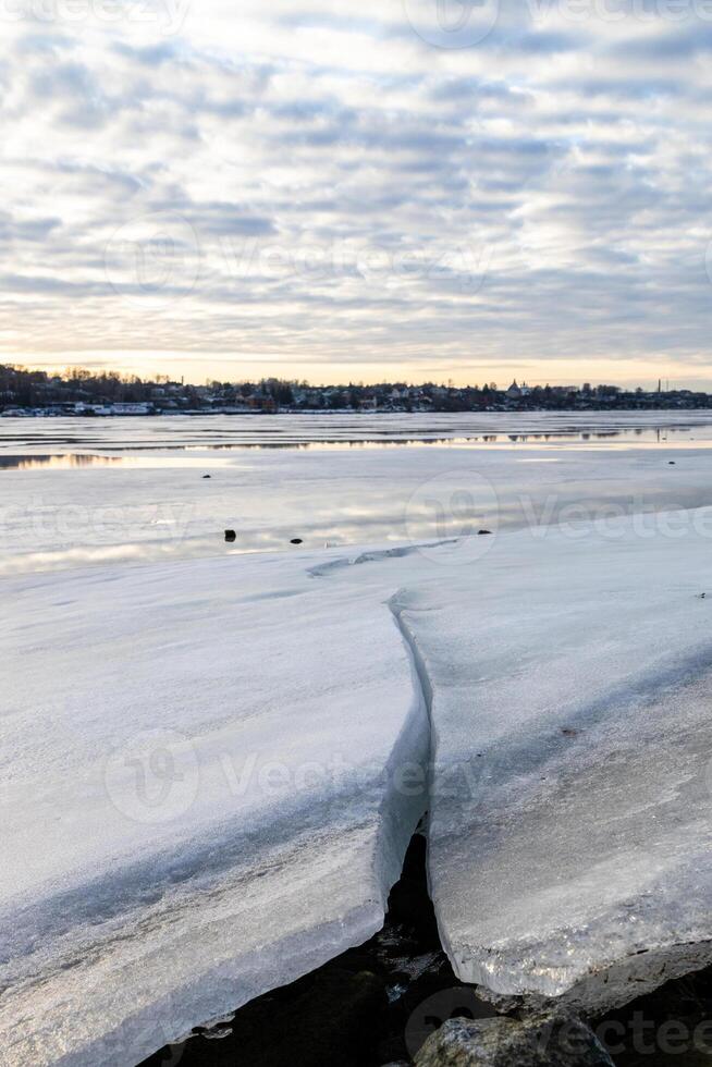 iced blocks on frozen river in Kostroma in winter photo