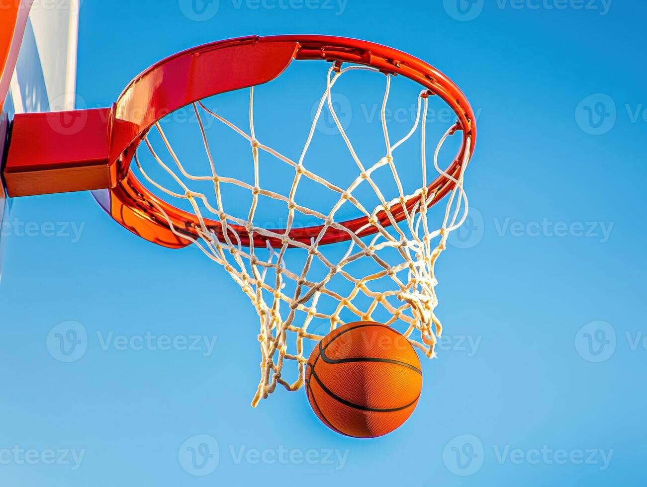 Basketball hoop with a ball nearing the net in clear sky photo