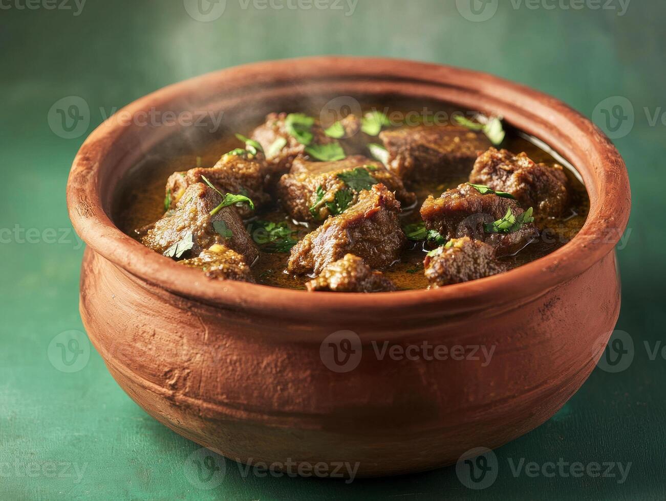 Delicious stew served in a traditional clay pot on a textured surface photo
