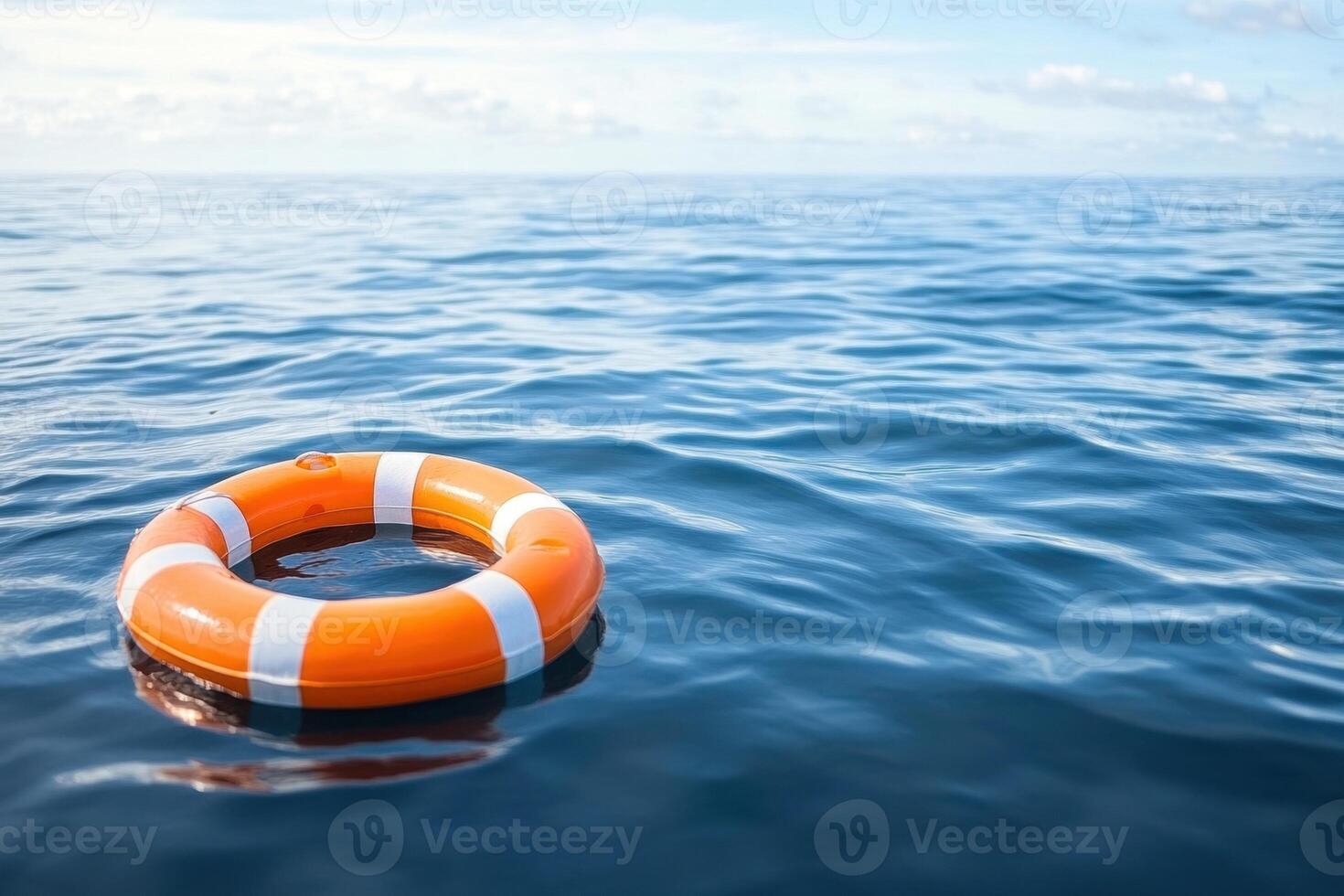 Lifebuoy floating in calm ocean waters under a clear sky photo