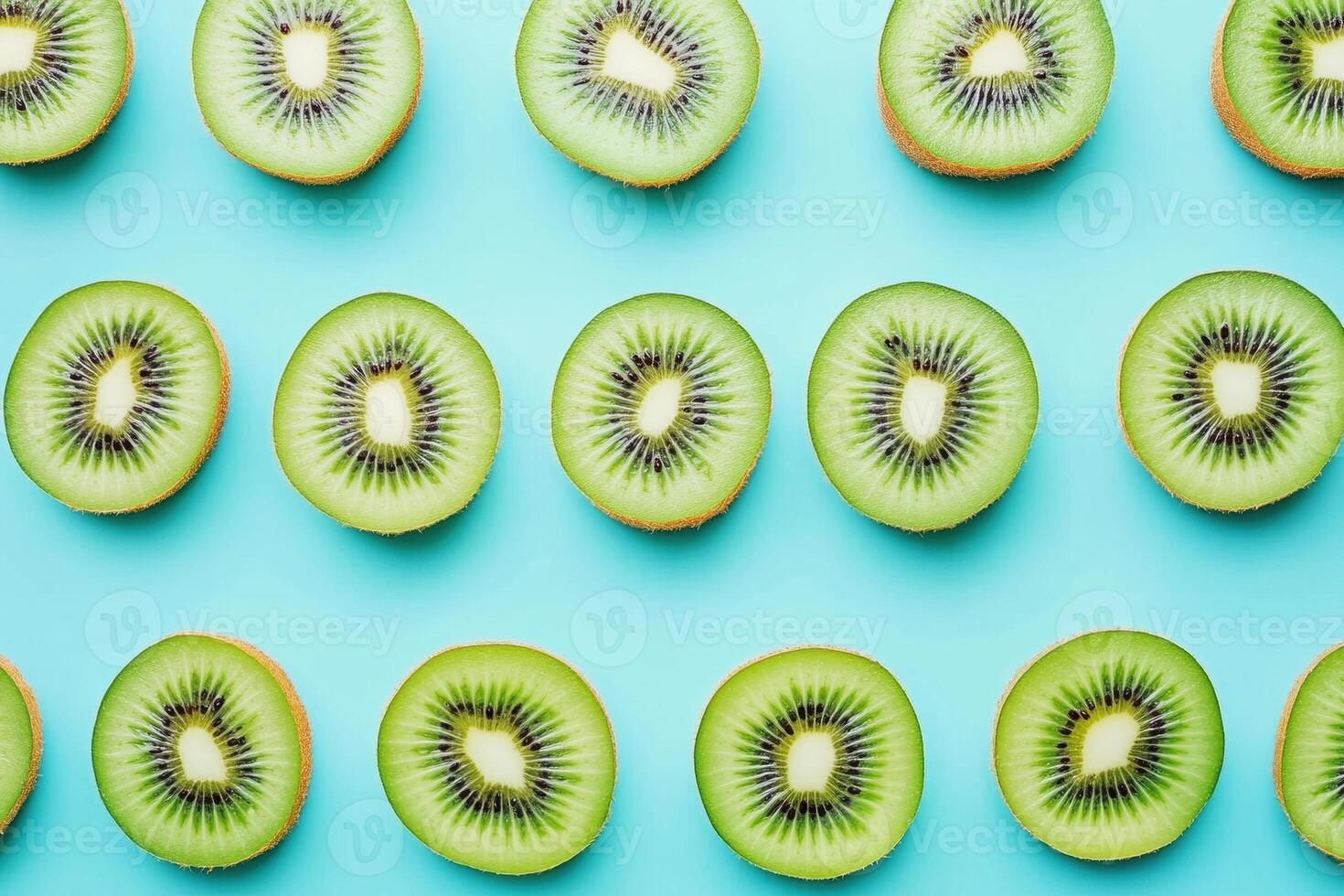 Freshly sliced kiwi arranged on a vibrant blue background photo