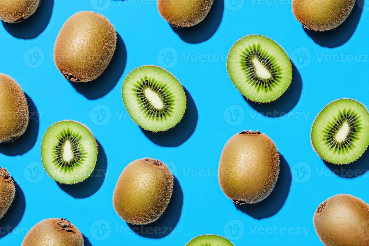 Fresh kiwi fruits arranged on a vibrant blue background photo