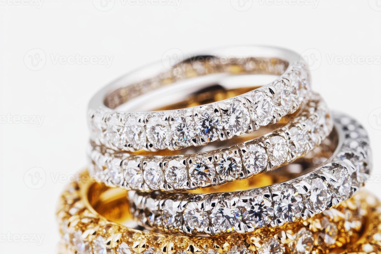 Elegant diamond rings stacked together on light background photo