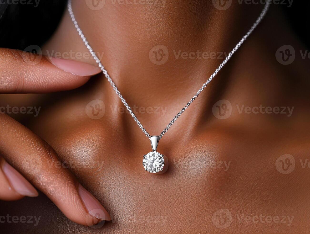 Elegant necklace with a sparkling pendant highlighted on skin photo